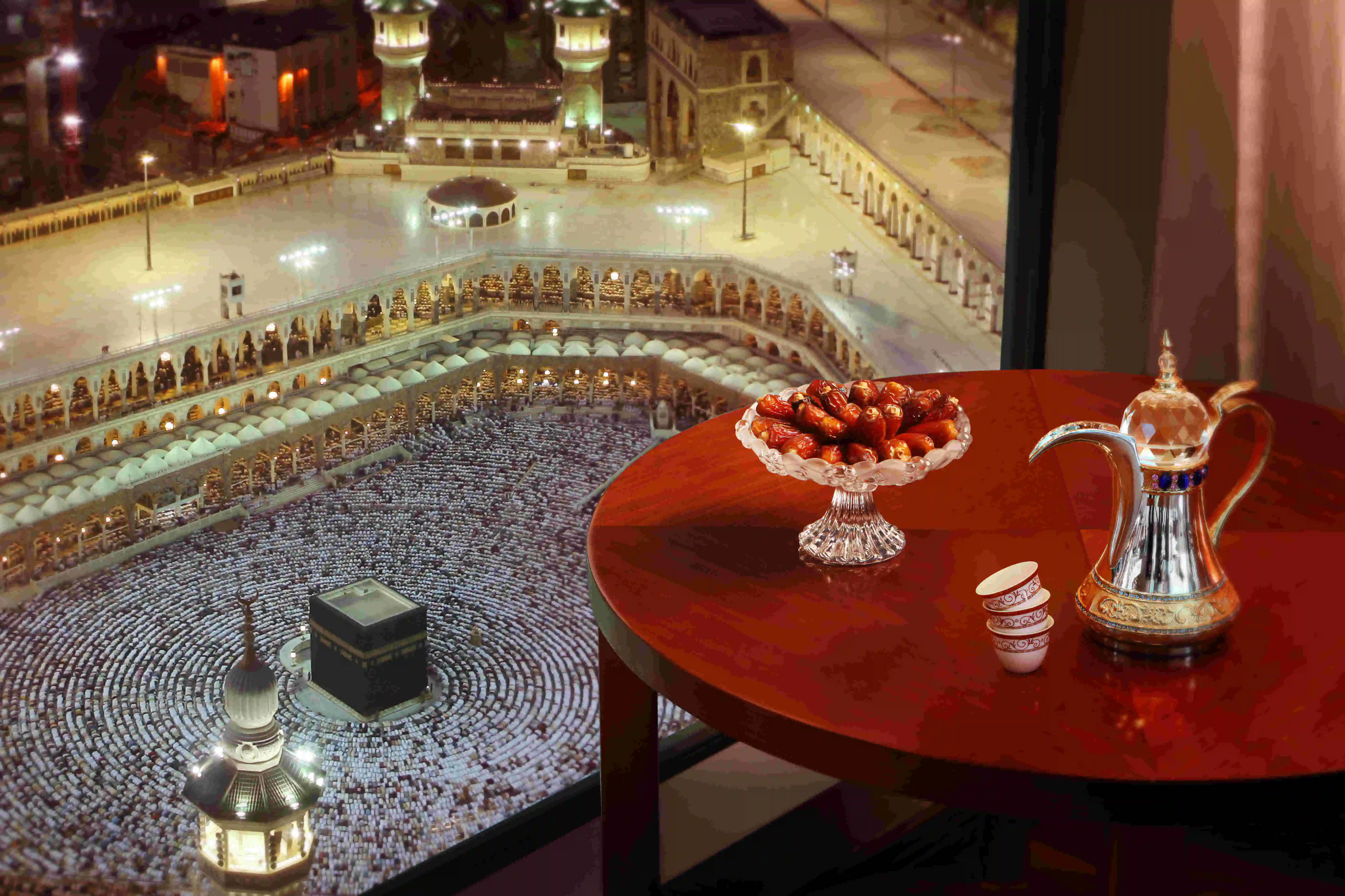 Stunning view of the Holy Kaaba and Al-Masjid Al-Haram seen from a guest room at Marwa Rayhaan by Rotana, featuring a traditional coffee set.