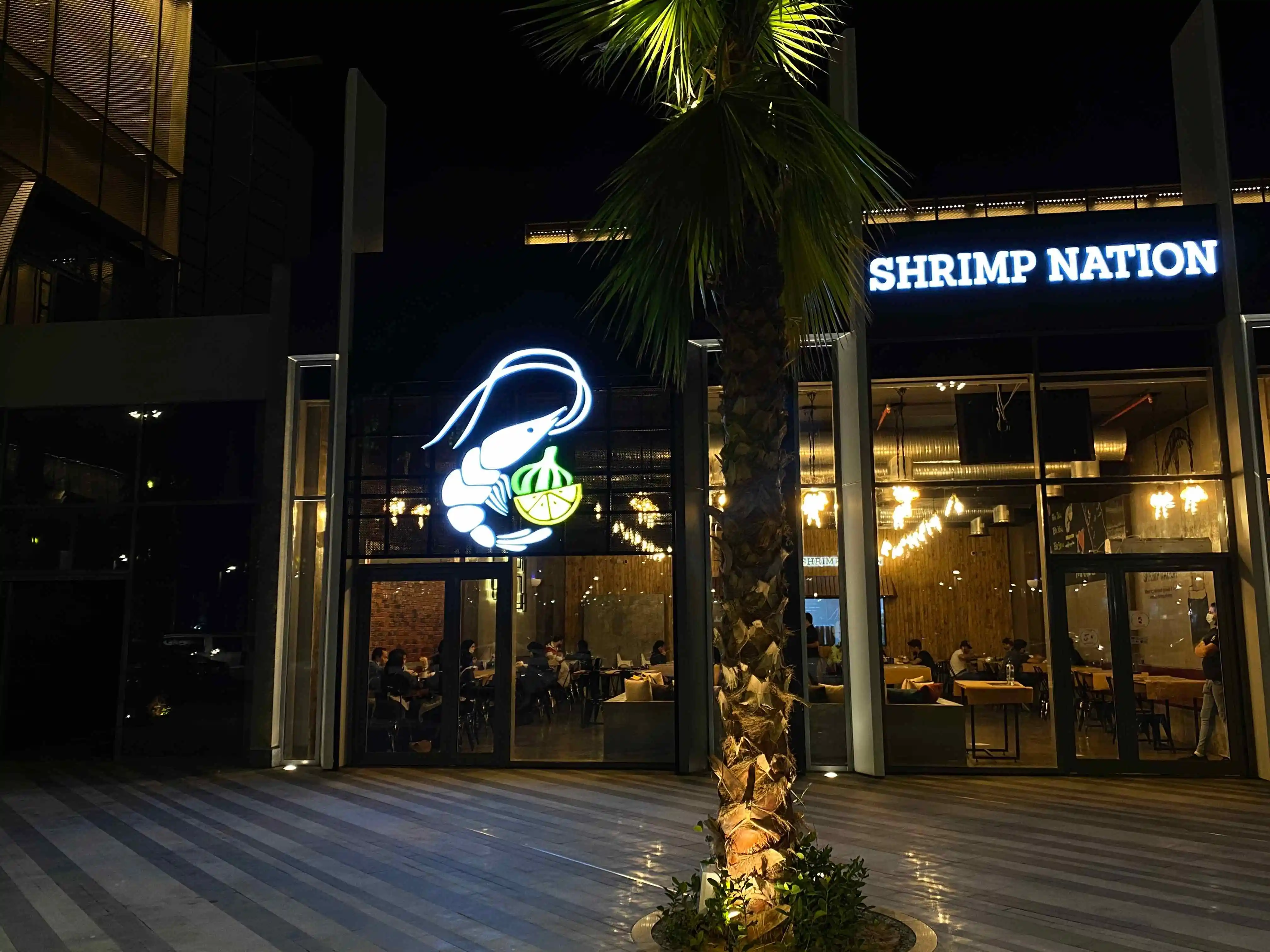 The outdoor signage and entrance view of Shrimp Nation restaurant.