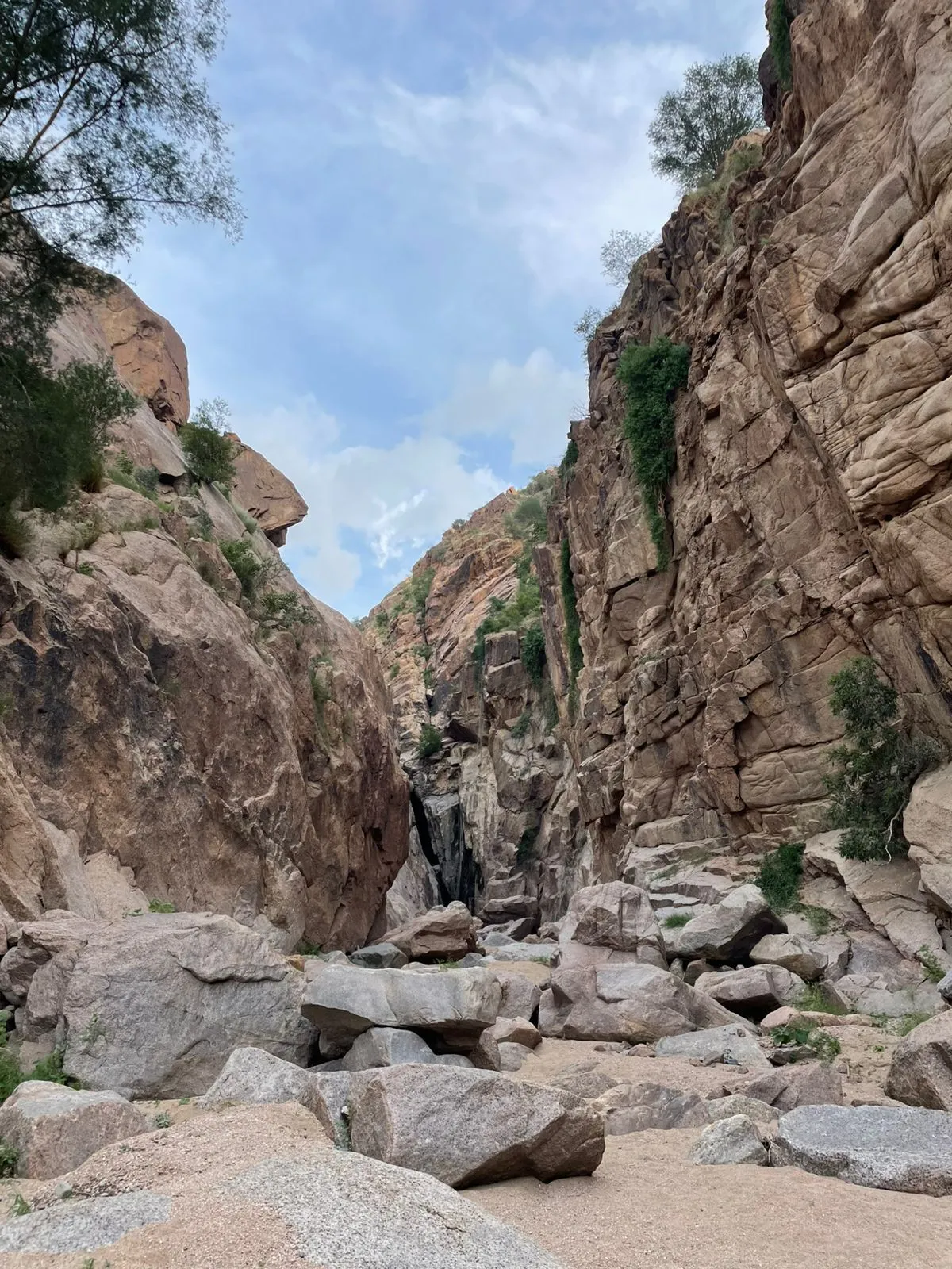 A narrow rocky canyon path during a hiking trip in Wadi Noaman, Makkah.