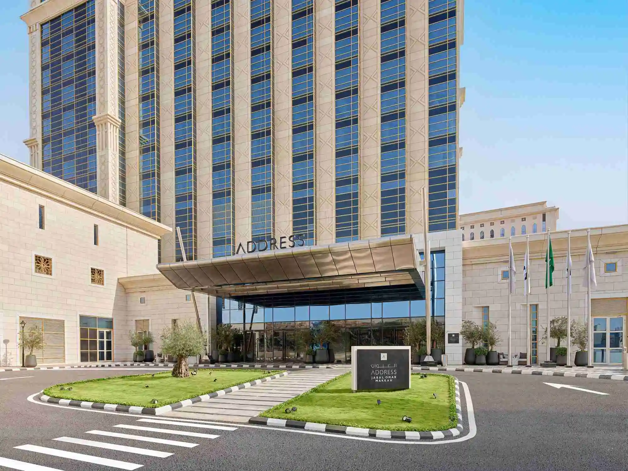 Exterior entrance and drop-off area of the Address Jabal Omar hotel in Makkah under a clear sky.