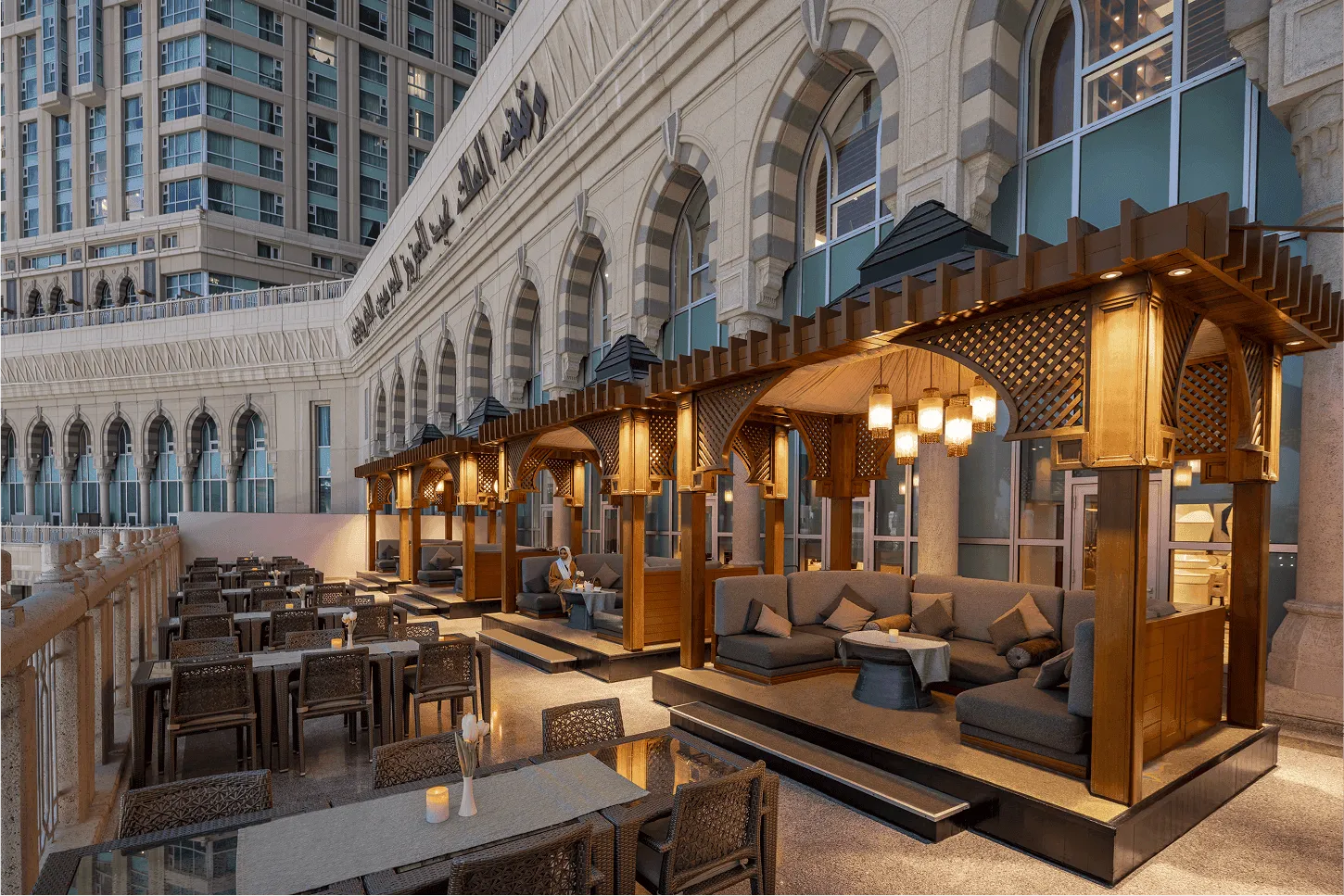 Outdoor terrace seating with traditional wooden gazebos at Raffles