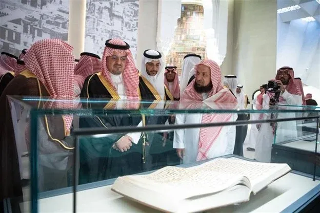 Official inauguration of the Quran Museum with officials viewing antique manuscripts in Makkah."