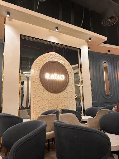 Modern interior seating area of Ratio Speciality Coffee featuring elegant decor and glowing logo